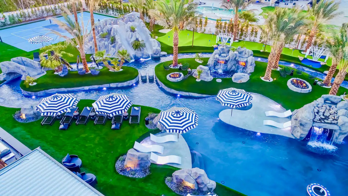 aerial view of the Lazy River Resort in Indio, California. The resort features a large private lazy river, multiple waterslides, and a main pool.