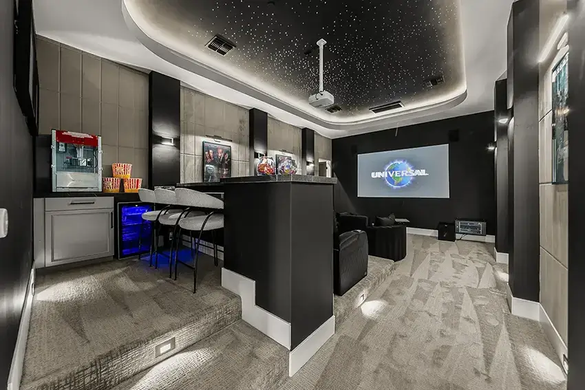 modern home theater room featuring a starry night-themed ceiling and a large projection screen