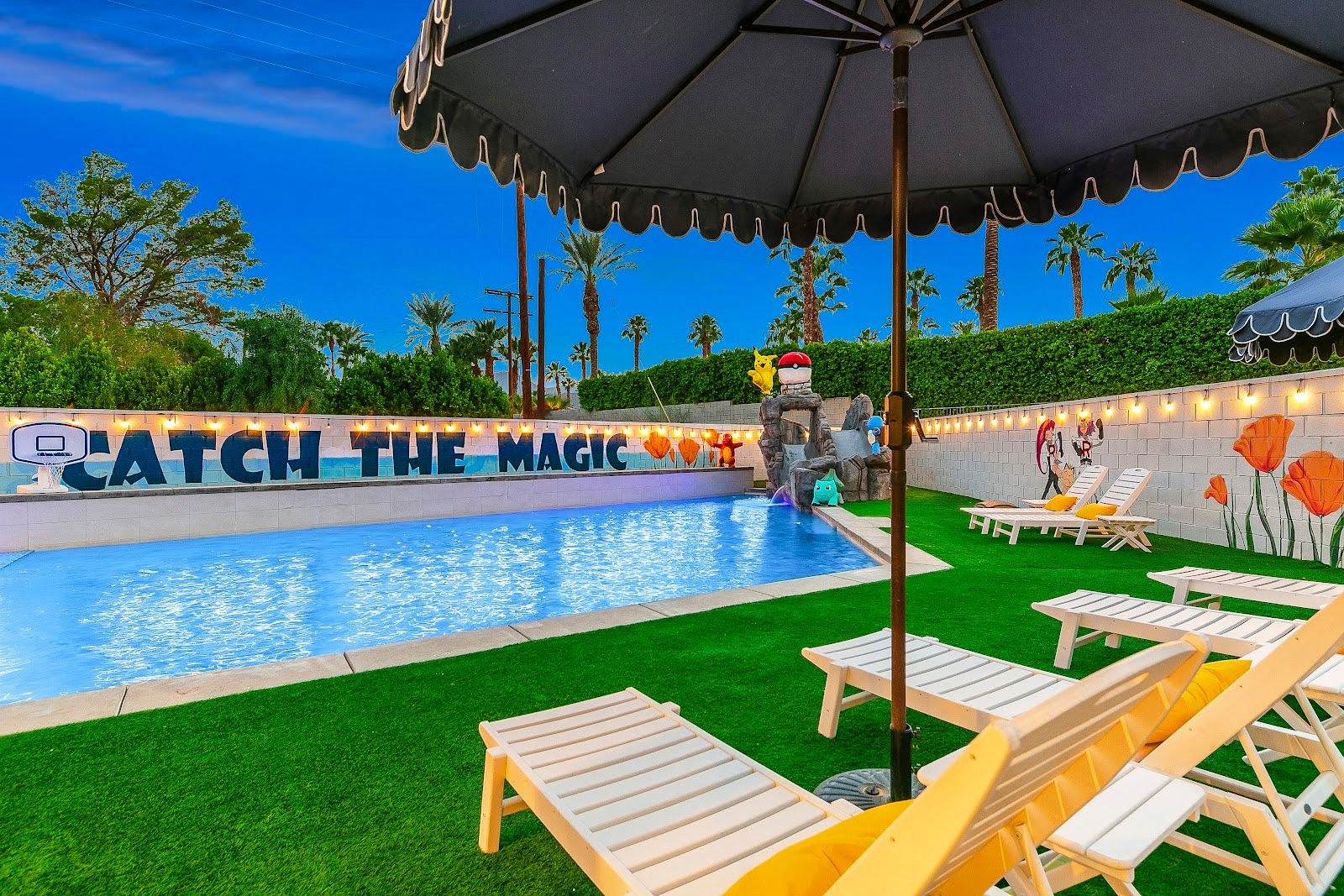 Luxury pool with lounge chairs and umbrellas